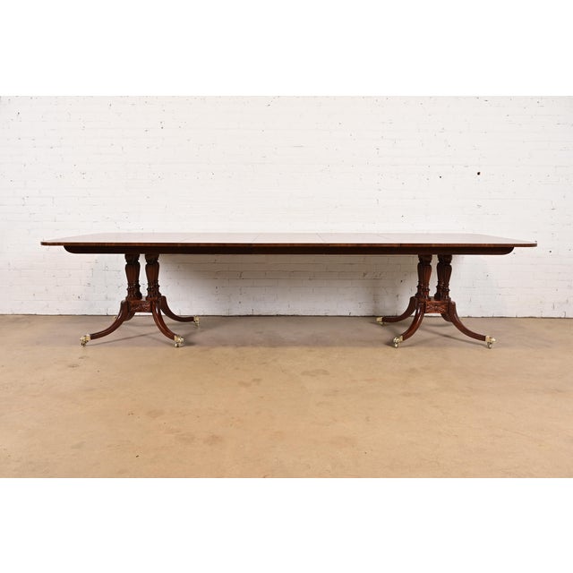 An exceptional Georgian or Regency style double pedestal extension dining table By Baker Furniture, "Historic Charleston"...