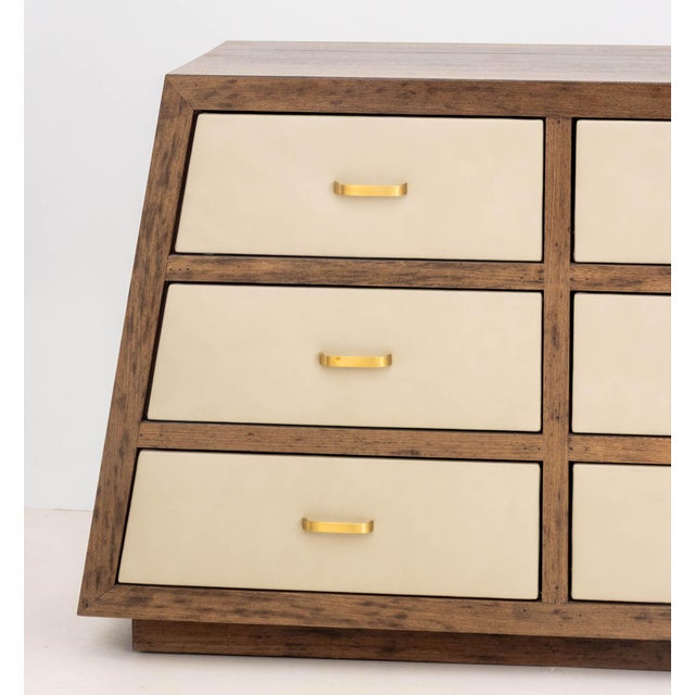Modern Mahogany Trapezoidal Dresser, with nine tan leather drawers and brass hardware. 36" H x 83.5" W x 20" D....