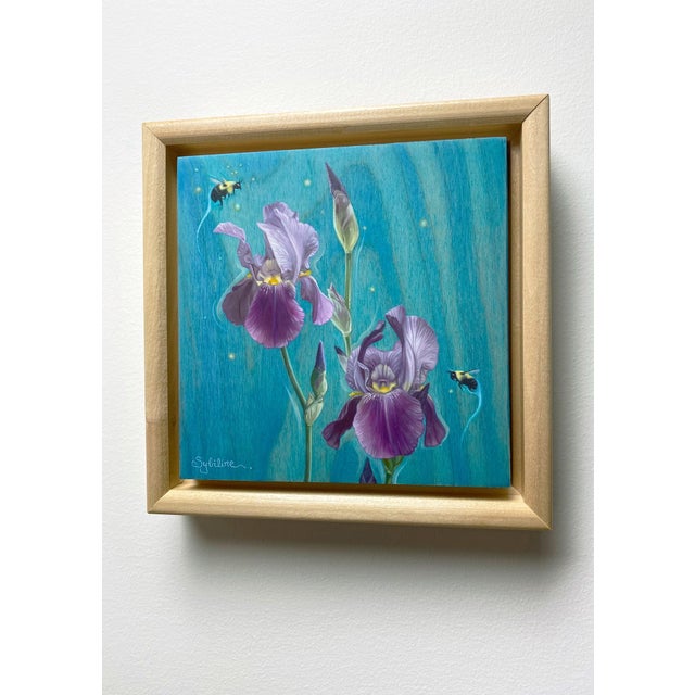 This oil on panel artwork features delicate purple irises set against a vibrant turquoise background, creating a sense of...