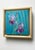 This oil on panel artwork features delicate purple irises set against a vibrant turquoise background, creating a sense of...