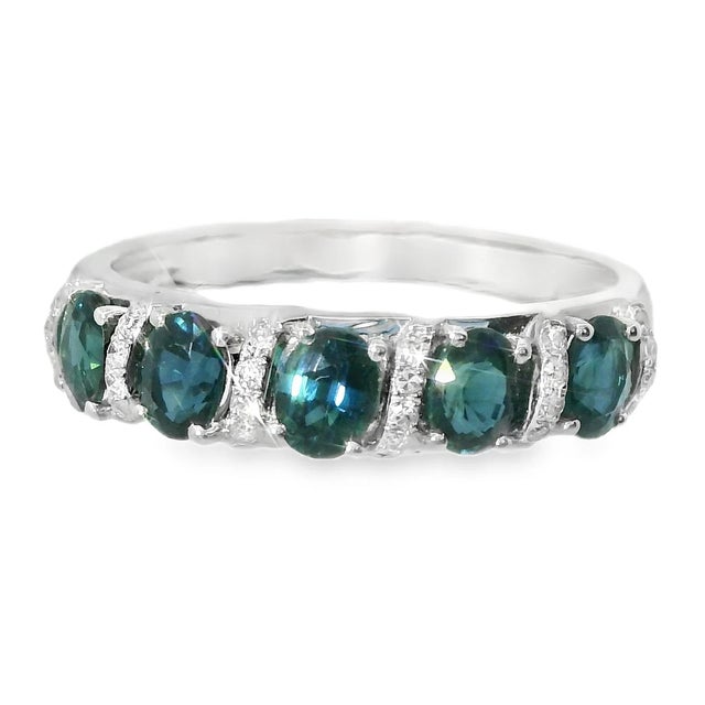 This stunning 14K white gold band ring features a classic five-stone design, showcasing vibrant natural sapphires...
