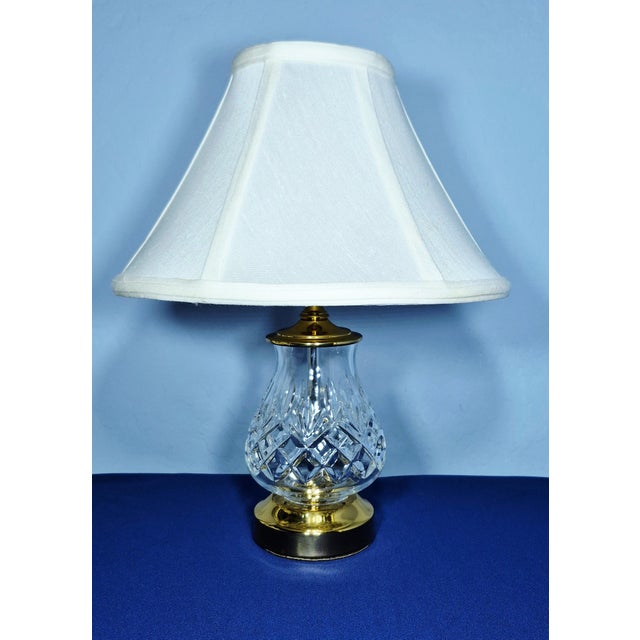 Set of two Waterford Fiona crystal and brass table lamps with an original Waterford white shade. Lamp measures 13 1/2"...