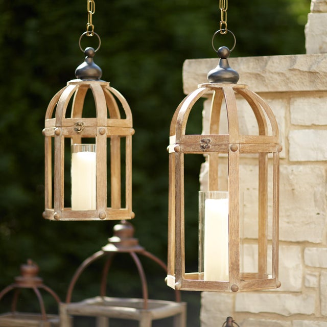 Elevate your home decor with this stylish set of Open Wood Lanterns featuring glass hurricanes. Perfect for adding a...