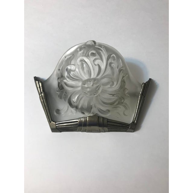 A pair of French Art Deco wall sconces signed by the French artist "Marius Ernest Sabino" Having clear and frosted glass...