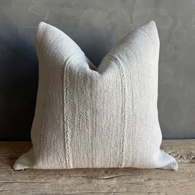 Creamy white hemp rug pillow with original seams. Soft hand, linen blend backing with zipper closure. Spot cleaning is...