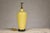 A crackle yellow glazed ceramic vase made into a table lamp and mounted on a circular wooden base with petite feet. This...