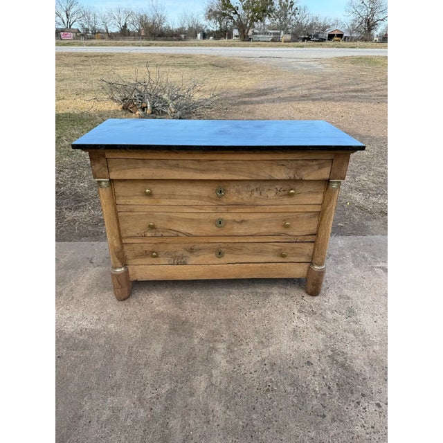 19th Century French Empire Commode from France. Made of solid walnut, with a black marble top, the wood was professionally...