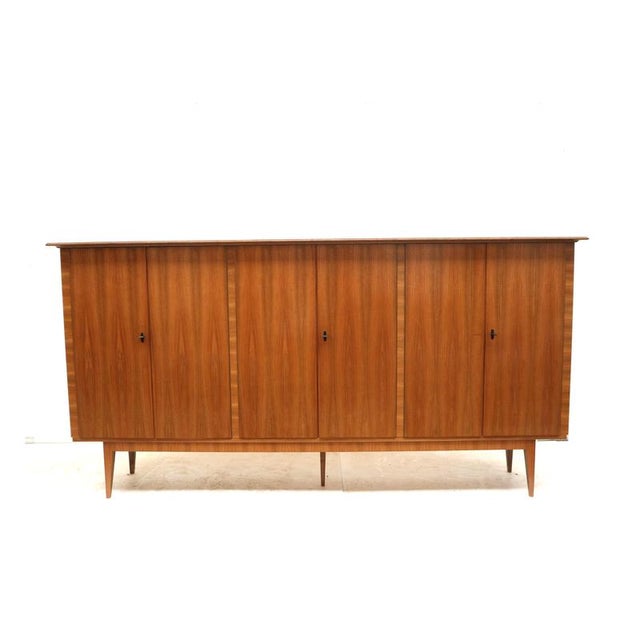 XXL Vintage highboard / tall sideboard made in the 1970s. Large vintage highboard from the 1970s with a sleek design and...