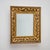Rectangular giltwood wall mirror with applied stucco decoration of grape clusters and foliage, framed by a cymatium frieze...