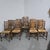 A super set of twelve oak and rush seated Lancashire ladder backed dining chairs, ten singles and two carvers, in...