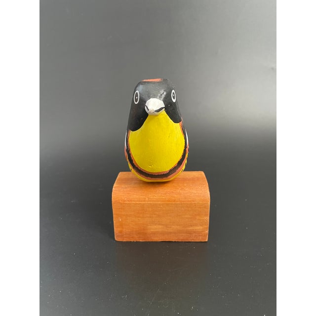 A hand crafted and hand painted small wood Oriole on stand. Nice condition with slight overall wood and paint wear. No...