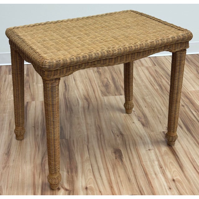 Vintage tightly woven wicker side table featuring raised table edges with scalloped aprons and woven legs. Sturdy with age...