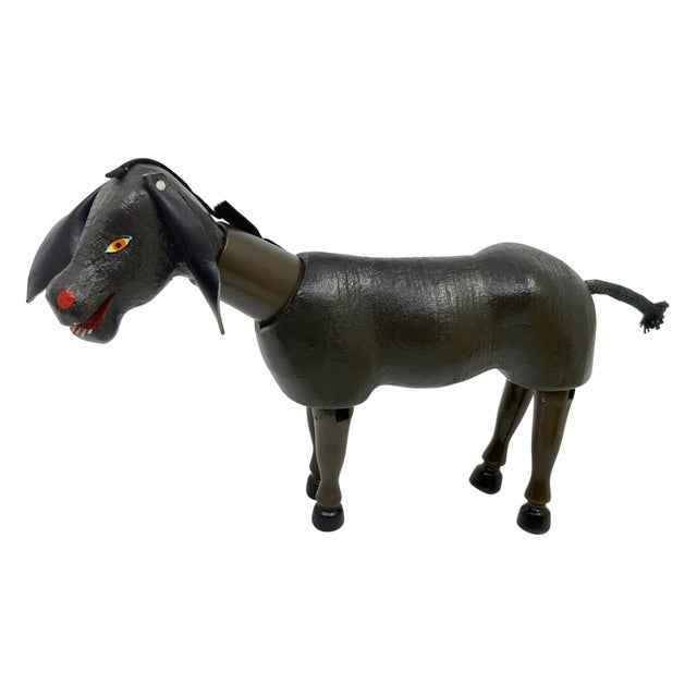 Vintage Shoenhut wooden donkey toy from Humpty Dumpty circus. Leather ears, jointed legs and a cord tail A unique rustic...
