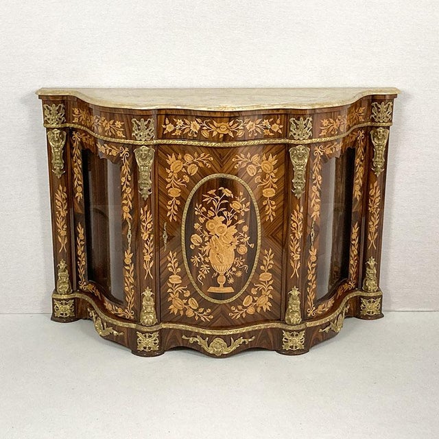 English three-door Louis XV-style sideboard in walnut and burl walnut with a marble top. It features rich inlays...