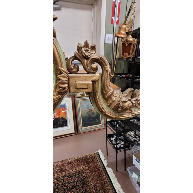 Large Antique French style mantel mirror. Circa 1930s large French mantle mirror featuring a hourglass shape trimmed in...