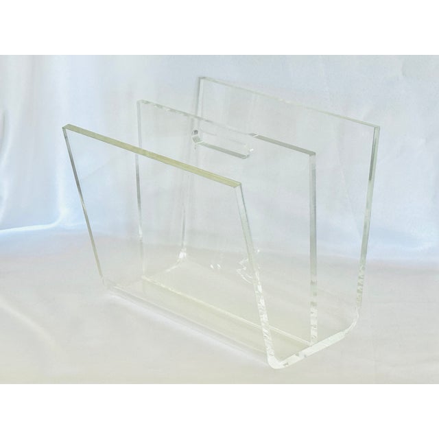 A bent lucite magazine holder with divider and cut-out handle. Thick half inch lucite of fine quality. Minimalist design...
