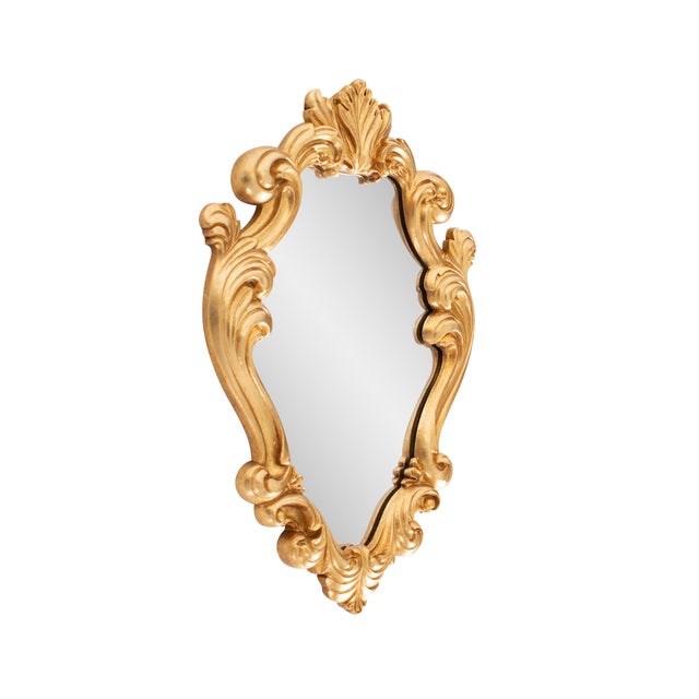 Finished in a luxurious antique gold, the ornate frame adds a touch of classic sophistication, making it a perfect accent...