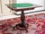 Hand-carved 19th century game table on a central leg divided by a tripod. Fine floral carving. Inside the table is a...
