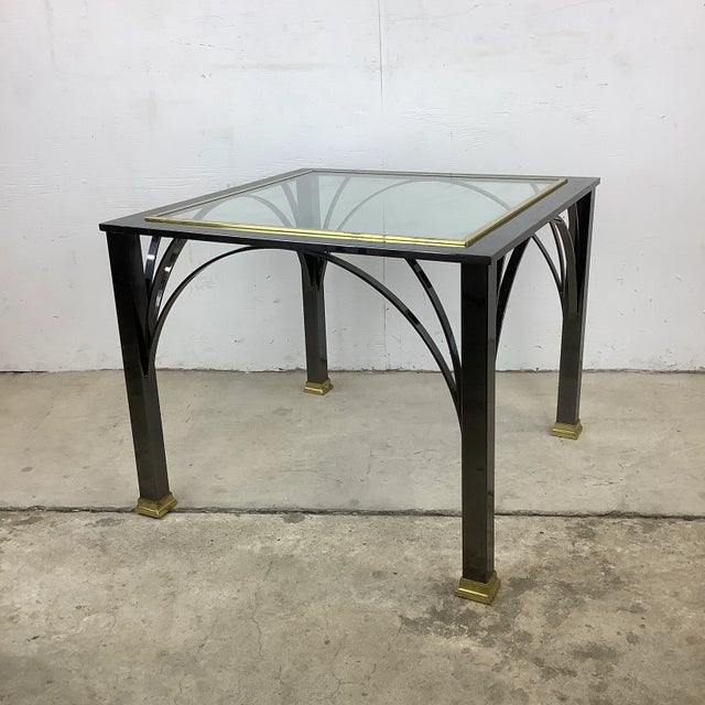 This stylish modern end table features an elegant mix of dark chrome and brass details, a sturdy table that makes an...