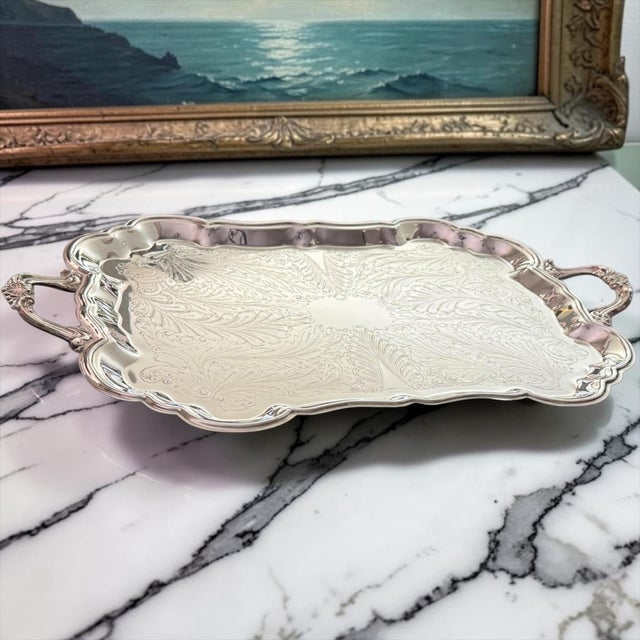 Elegant and generously scaled, this vintage F.B. Rogers silverplate butler’s tray features a beautifully engraved surface...