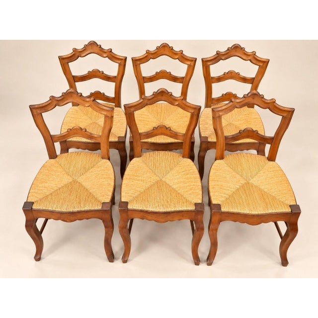 Set of six Louis-Philippe period chairs in stained fruitwood, with openwork backs featuring two carved crossbars decorated...