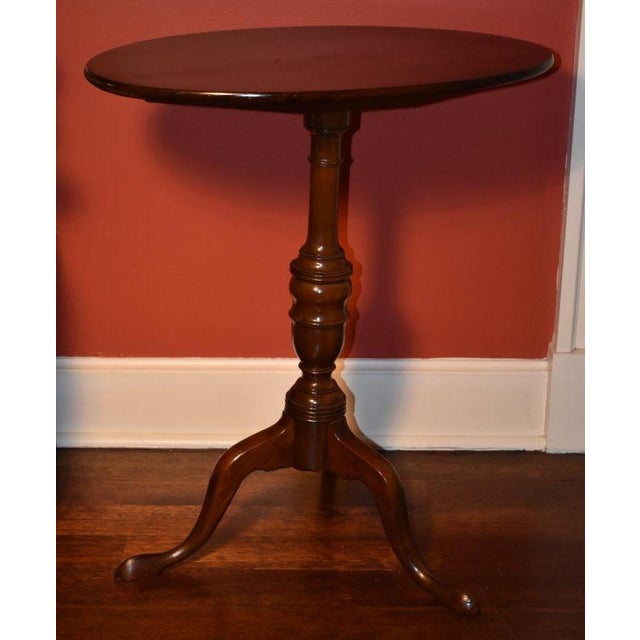 American mahogany candle stand, mid 1700s. The graceful oval top is of one board with a molded edge and is made to tilt...