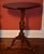 American mahogany candle stand, mid 1700s. The graceful oval top is of one board with a molded edge and is made to tilt...