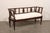 An Italian Neoclassical style carved fruitwood sofa bench, with cushion seat, from the 19th century. This antique settee...