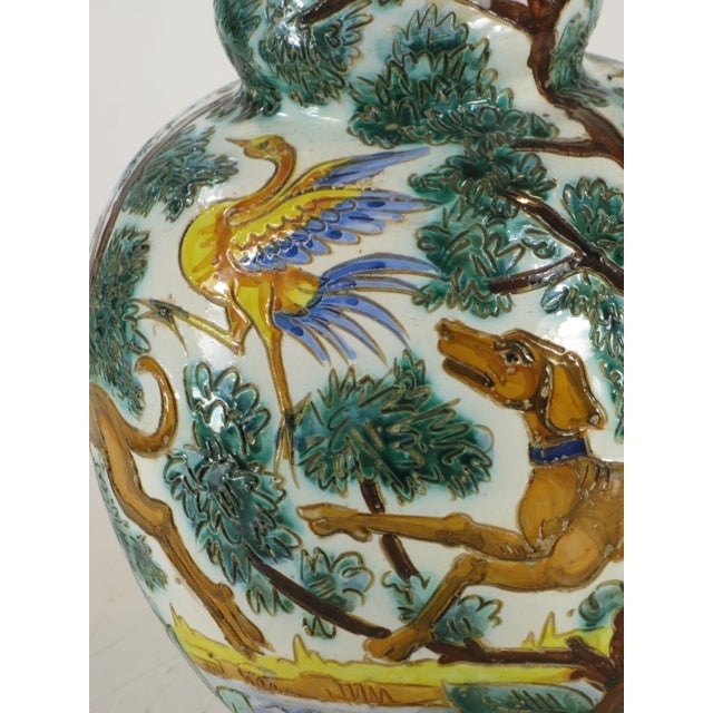 This large ceramic vase is a beautiful Italian Majolica piece featuring a Neo-Classical design with three dogs and birds....