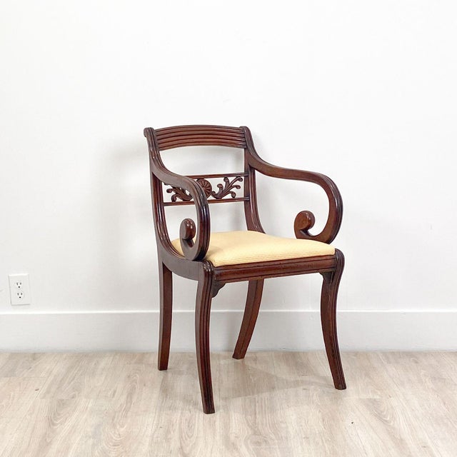 A pair of English Regency period armchairs. Good color and patina. Upholstery could be updated. On sabre legs. Circa 1820....