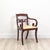A pair of English Regency period armchairs. Good color and patina. Upholstery could be updated. On sabre legs. Circa 1820....