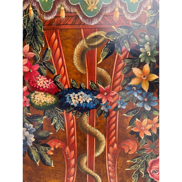 This large decorative painting on wood panel features a classical floral arrangement presented in an urn atop an ornate...