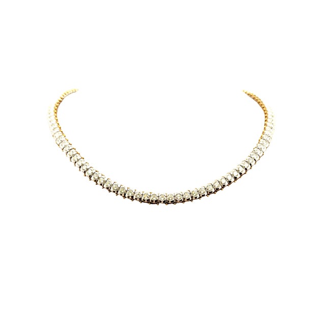 A refined tennis necklace featuring round-cut white diamonds, totaling 15.88 carats. Each diamond is meticulously set,...