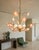 An exquisite and rare 1970s Italian chandelier featuring hand-blown Murano glass shades shaped like delicate blooming...
