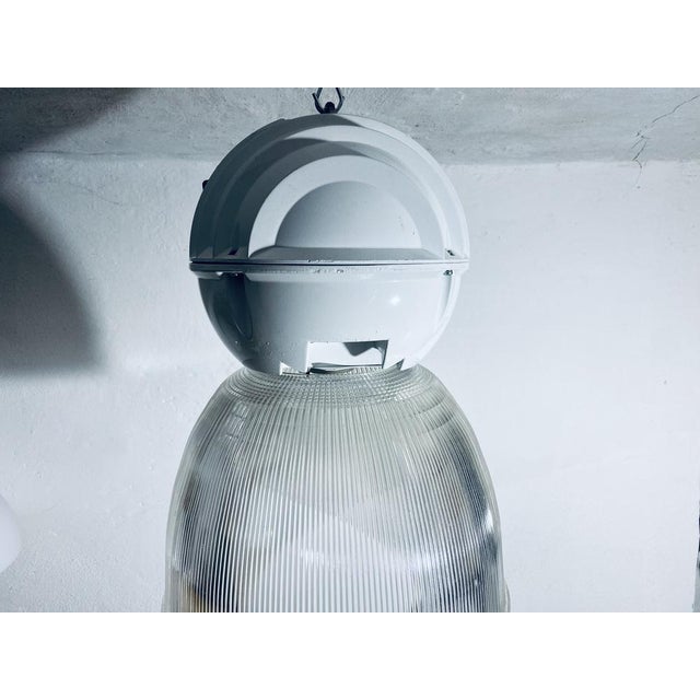 Industrial Lamp in Glass and Metal by Holophane, 1980s, in Worn conditions. Designed 1970 to 1979 This piece has an...