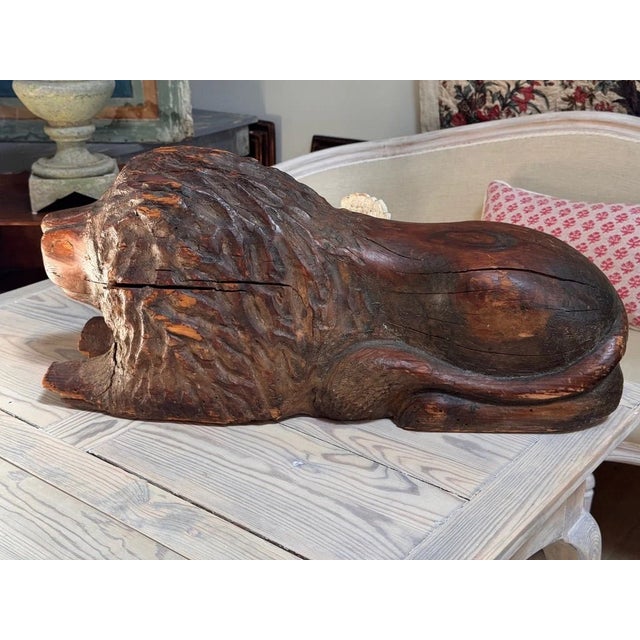 Exceptional Carved Recumbent lion, c. 1740, carved of solid wood. Measures 12''h x 28''l x 12” w. Restorations.