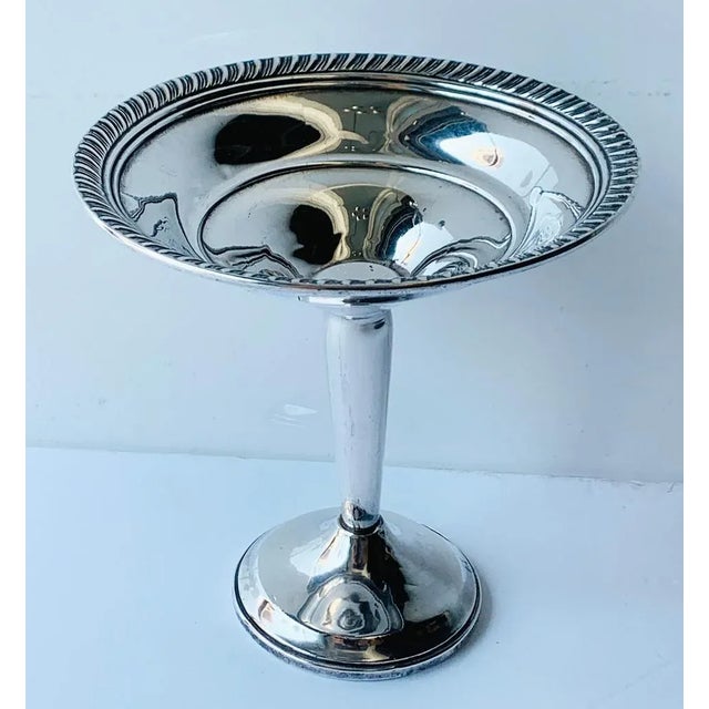 This is a small beauty. Gadroon/rope border around top and bottom edge as well as reticulation of the shallow bowl....