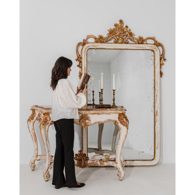 A 19th century Venetian console and mirror set in the neo-Rococo style, featuring a carved wooden structure with a...