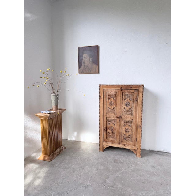 Small cabinet in a compact size, crafted from solid wood with carved decorations. inspired by folk art, this exotic...