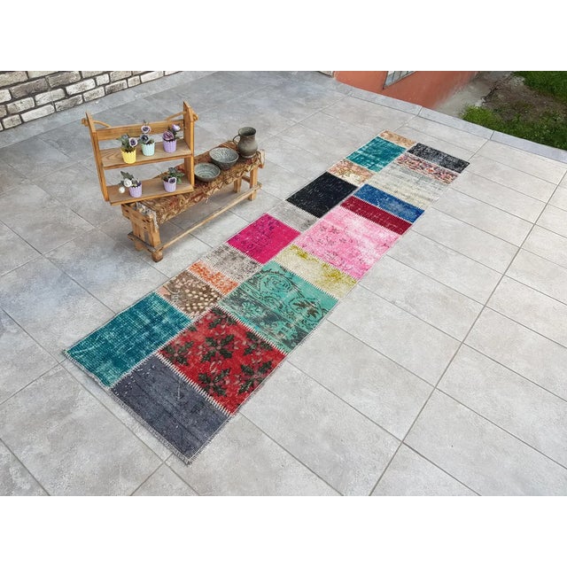 This is a vintage Turkish Oushak rug from the Mid 20th Century. The piece was hand-knotted.