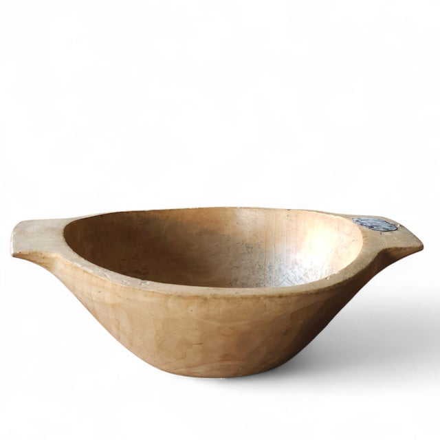 A soulful example of early American folk craftsmanship, this unmarked wooden bowl likely hails from the Northeastern or...