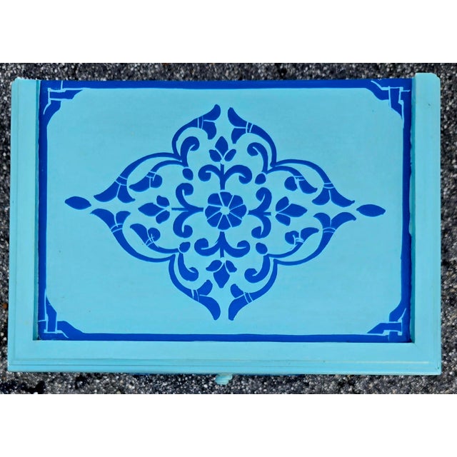 A stunning hand‑painted Moroccan nightstand showcasing the vibrant artistry and traditional Zoua9 woodwork Morocco is...