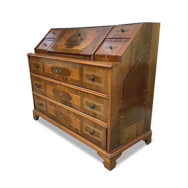 Antique Trentino Drop-Leaf Chest Veneered in walnut, decorated with geometric maple and cherry trim. The front of this...