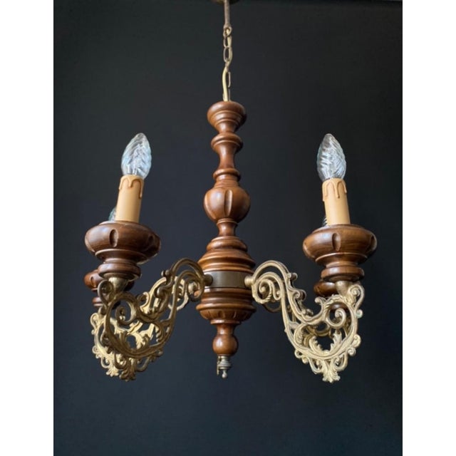 The chandelier is made of brass and features exquisite artistic wroughtwork. It is adorned with handcrafted wooden...