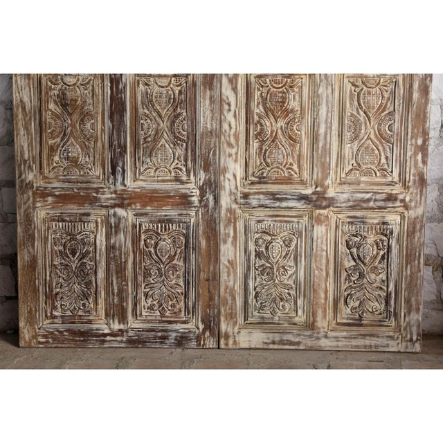 A breathtaking fusion of history, artistry, and architectural charm, these vintage carved double barn doors feature a soft...