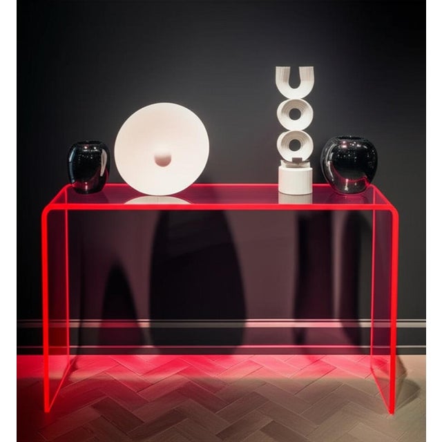 Our neon pink console table floats in a room without permanent visual seating. In a single continuous turn, thick-cut...
