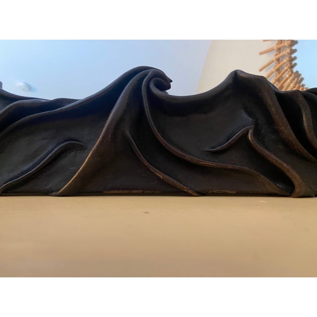 A striking and highly unusual vintage French wall mirror featuring two sculptural, three-dimensional faces surrounded by...