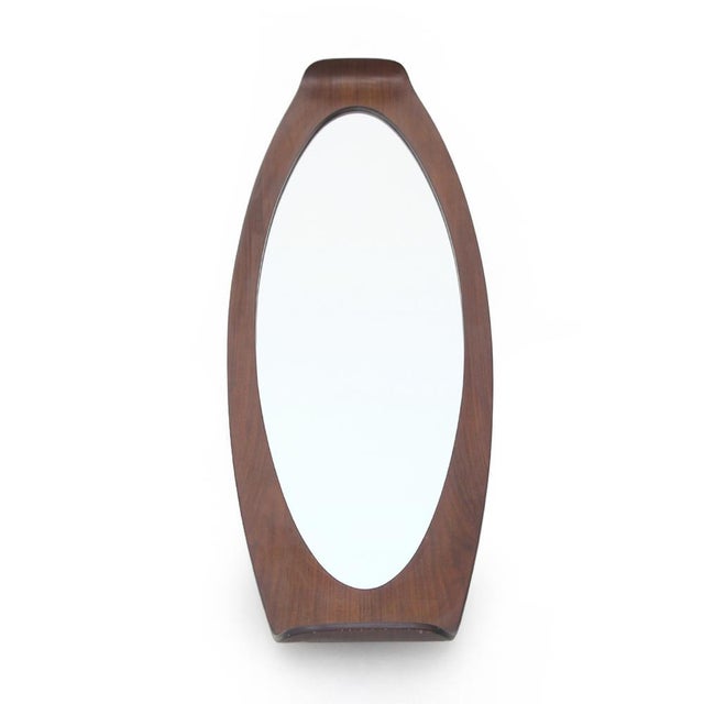 Italian manufacturing mirror produced in the 1960s. Curved plywood frame with the teak veneer. Oval mirror. Good general...