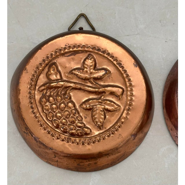 Pair of vintage French Country hanging copper molds with tin lining. Pear and grape motifs. Please see condition details...