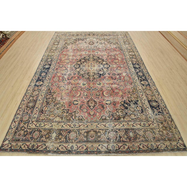 An authentic vintage traditional Mashad rug hand-knotted with fine wool and natural dyes. This oriental rug features a...